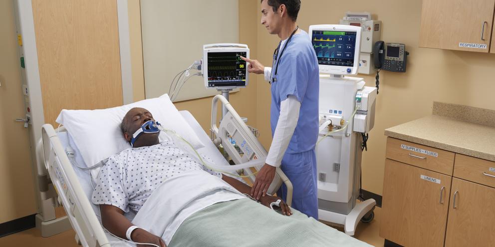Clinician checking on a patient on a spirometer