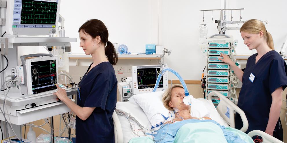 Clinicians taking care of a woman in the ICU