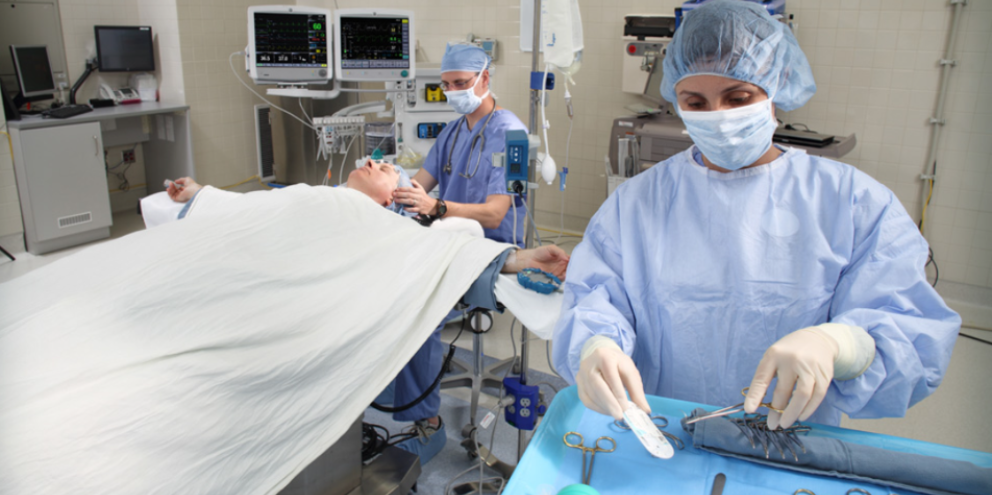 3 Surgeons in the OR operating a patient 