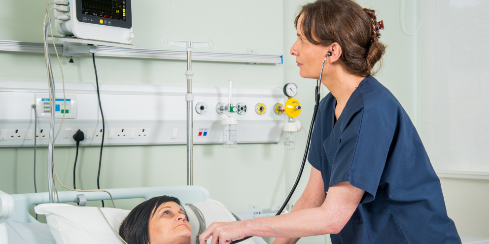 Clinician taking care of a patient in ward