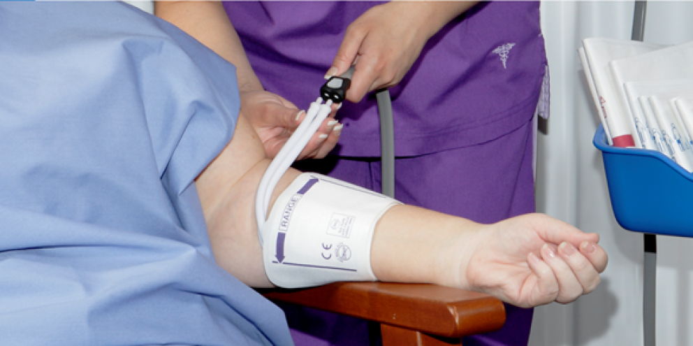 Clinician setting a NIBP cuff to a patient