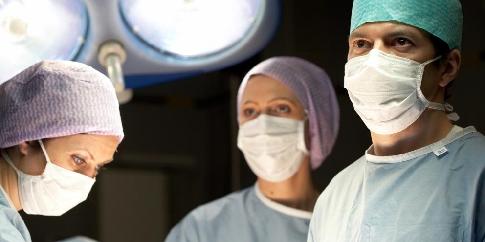 Clinicians looking at a monitor in the operating room