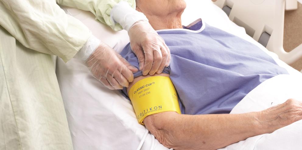 Clinician placing a cuff on a elderly patient