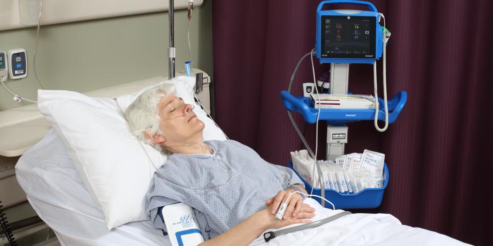 Patient laying in bed being monitored by monitor VC150