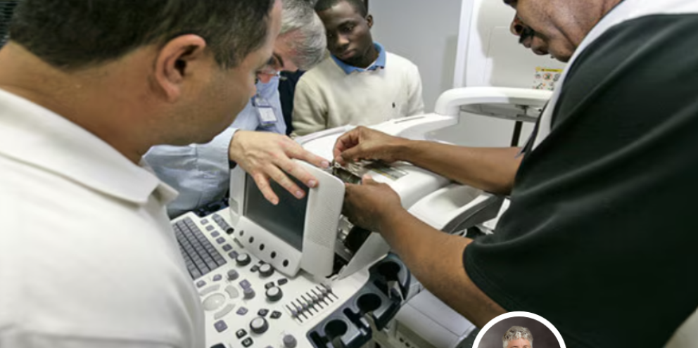 3 biomeds studying a medical device