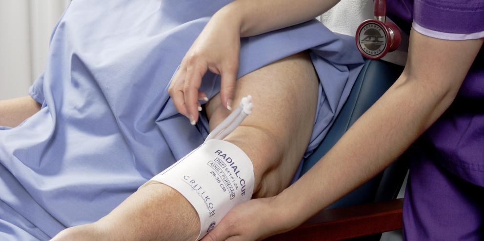 Clinician applying a cuff to a patient