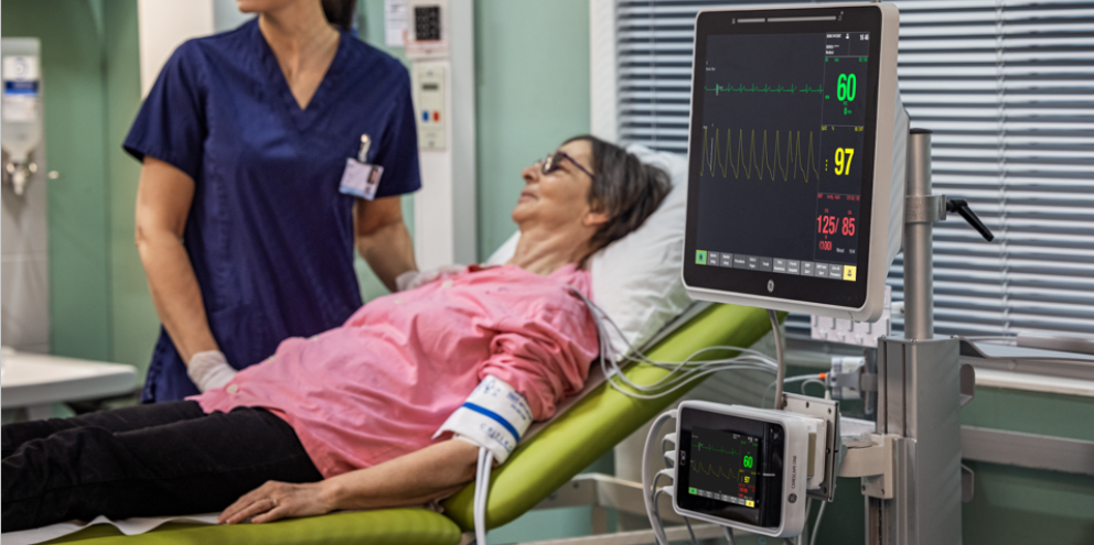 Female clinician taking care of a female patient on the ward