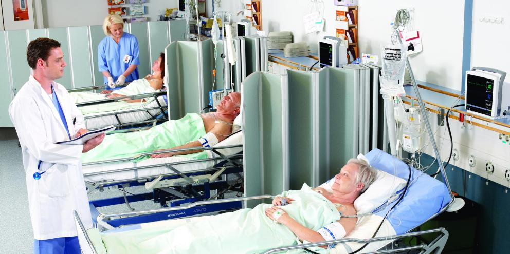 Doctor checking on patients in the PACU