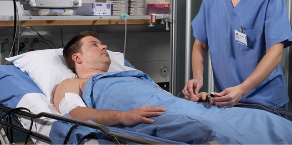 Patient in the ward being checked by a clinician