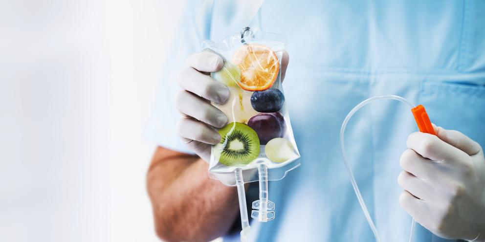 Clinician holding an IV bag full of fruit