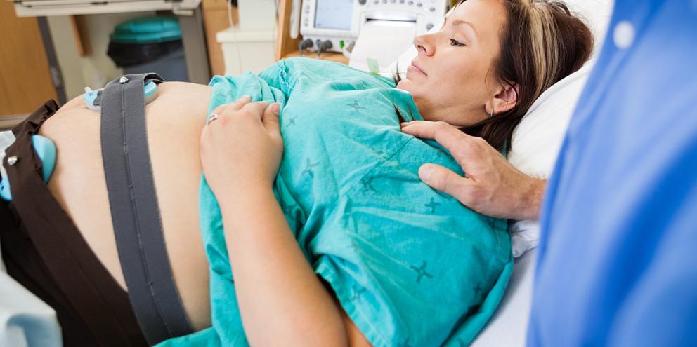 Pregnant women looking at her belly