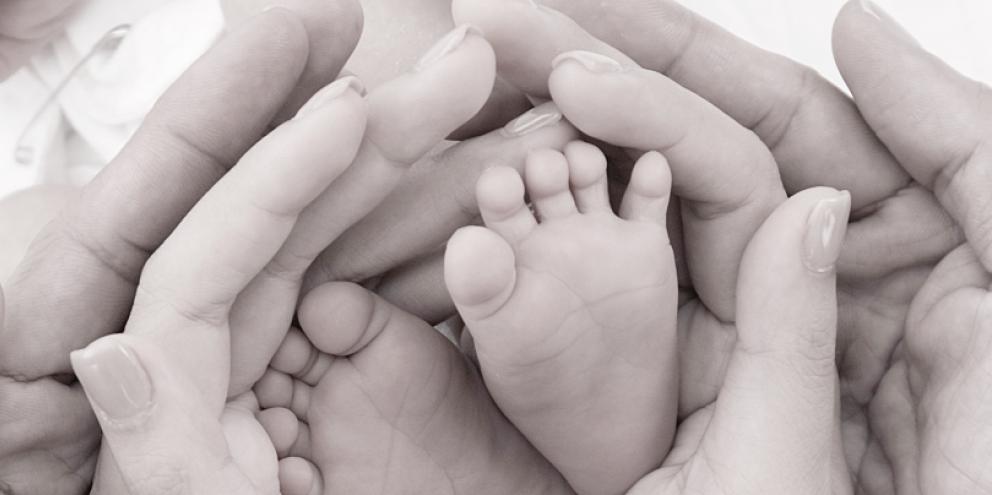 Baby feet and parents hands