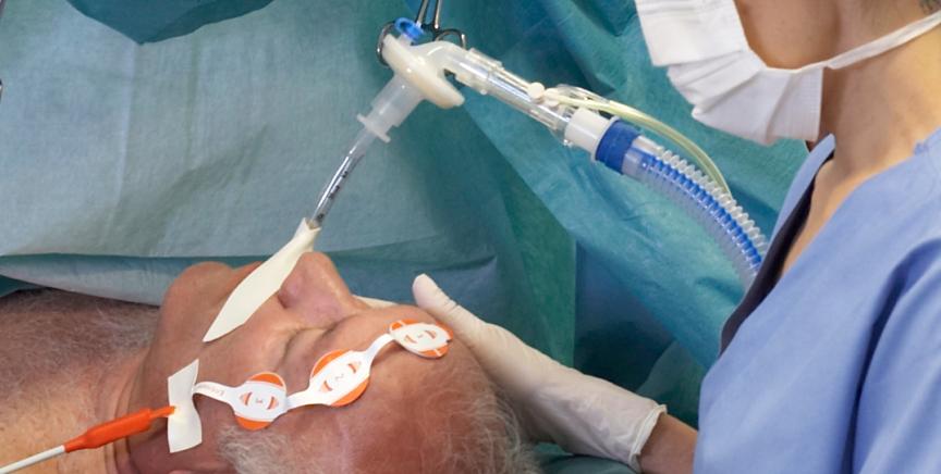 Clinician giving anesthesia to a patient