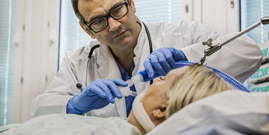 Clinician putting a patient on mechanical ventilation