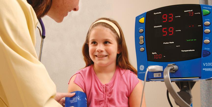 Doctor using the V100 monitor on a pediatric patient