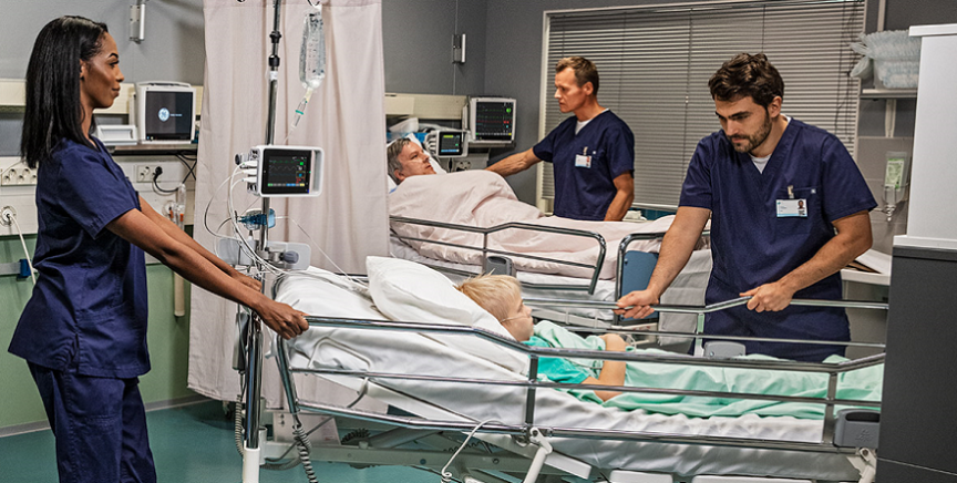 Clinicians taking care of a patient in PACU