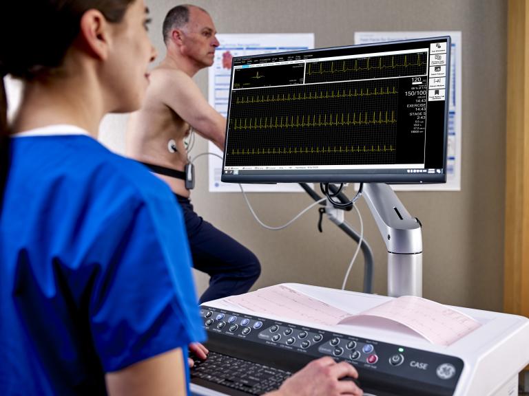 Male patient doing a stress test and clinician monitoring him