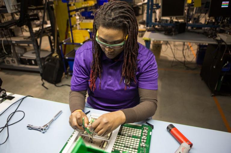 Clinical engineer repairing the electrical wiring of a medical device