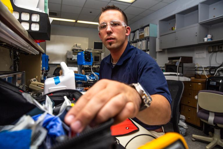 Biomedical engineer testing a patient monitor