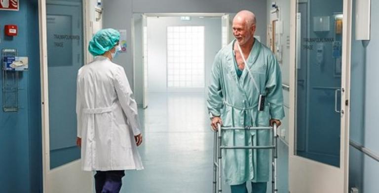 Patient and clinician walking in a hospital