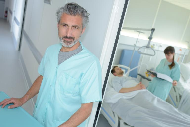 Clinicians taking care of patient in critical condition post-operatively