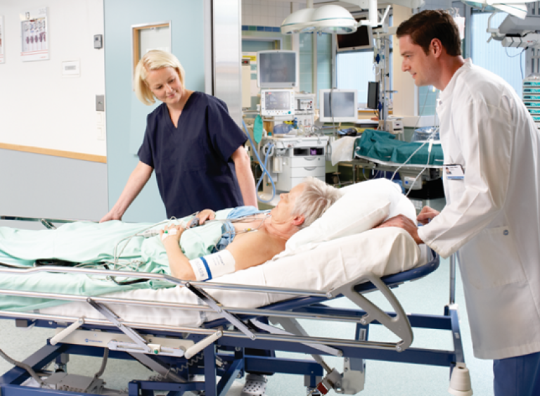 Women with an ECG being transported by two clinicians