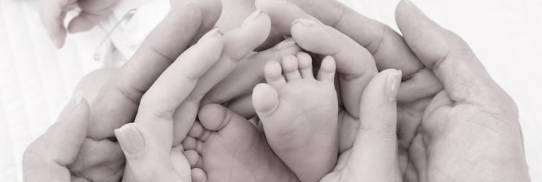 Baby feet and parents hands
