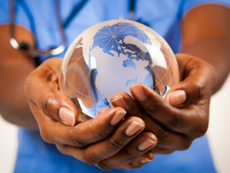 Earth globe between a clinicians hands