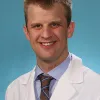 Dr. Adam May