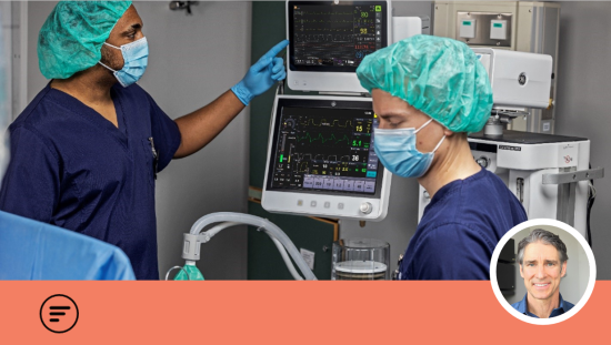 Two clinicians in the operating room with an anesthetized patient