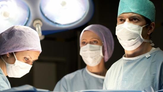 Clinicians looking at a monitor in the operating room