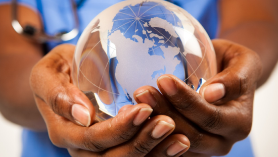 Earth globe between a clinicians hands