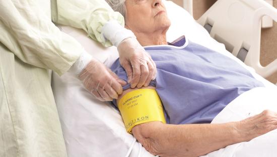 Clinician placing a cuff on a elderly patient