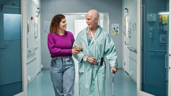Patient and clinician walking in a hospital