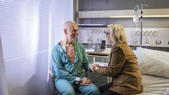Patient sitting down with his wife in the ward