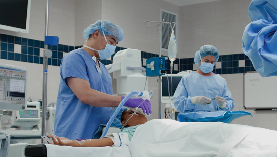 Three clinicians taking care of a patient