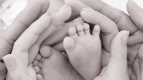 Baby feet and parents hands