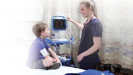 Clinician using CARESCAPE VC150 Roll stand on a patient