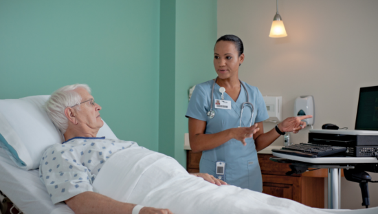 Nurse and patient talking in the ward