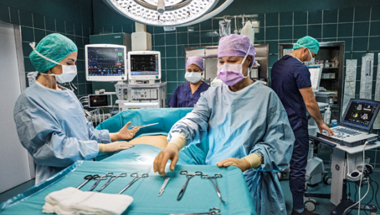 Four Clinicians in an OR performing surgery on a patient