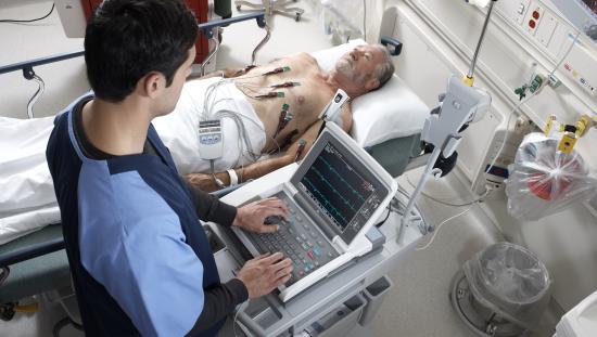 Clinician taking care of a patient with ECG leads