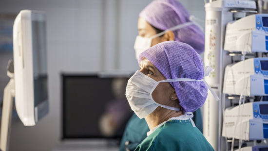 Clinicians looking at a screen in the Operating Room