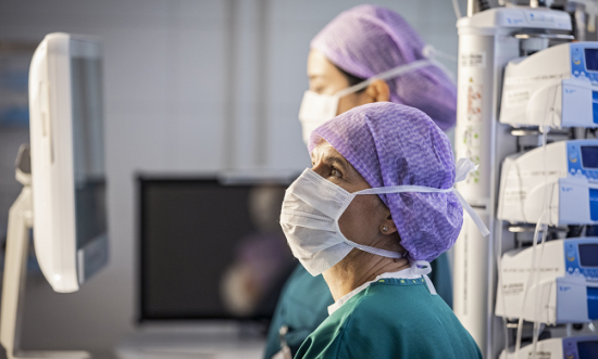 Clinicians looking at a screen in the Operating Room